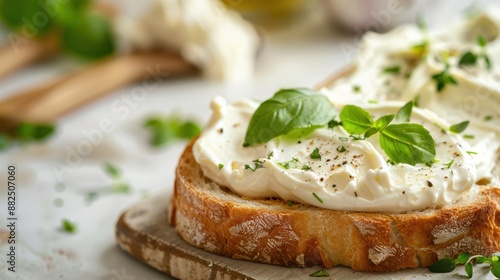 Close-up of a delicious slice of bread spread with creamy cheese and garnished with fresh herbs, perfect for a delightful healthy snack.