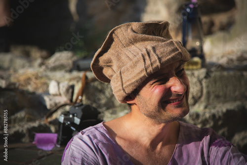 A male mercenary of Arab appearance in old clothes laughs. Close-up portrait