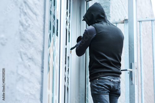 Man, intruder and crowbar for home crime, house invasion and breaking entering attempt with tool. Apartment, robbery and burglary or trespassing on property, security breach and owners safety risk