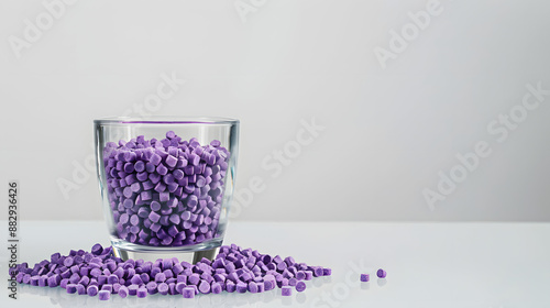 Close-up of purple plastic polymer granules. glass with Polymer pellets. polymer plastic. compound polymer.