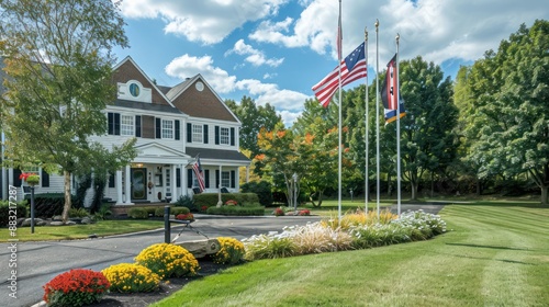 Suburban Colonial home with a stately flagpole in the front yard, displaying the flags of the homeownersa?? national heritage