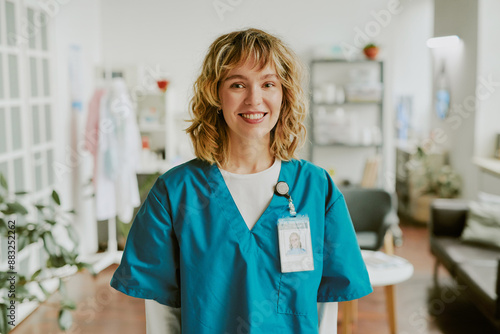 Portrait of blonde nurse looking at camera directly and smiling widely showing her teeth