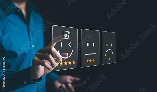 Customer review satisfaction feedback survey concept. Businessman interacts with virtual icons representing customer satisfaction levels, including happy, neutral, and sad faces, and feedback. rating,