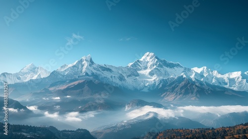 A panoramic view of a snow-capped mountain range under a clear blue sky