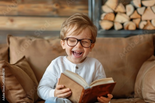 Beautiful brunette little boy wearing glasses and holding book smiling and laughing funny crazy joke concept