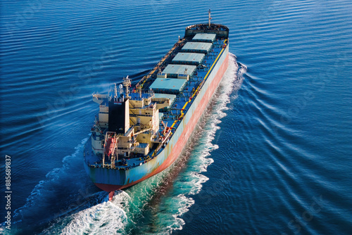 Bulk cargo carrier ship underway in calm sea. Dry cargo vessel merchant ship to transport bulk cargo such as grains ore coal