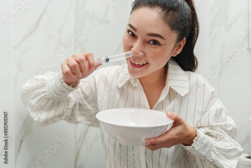 woman making nasal wash with using sryinge flushing inside nose