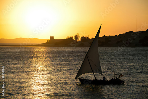 "A dhow sailboat at sunset off the coast of Lamu, Kenya"