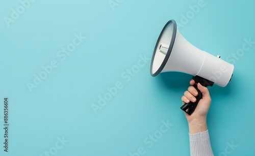 Hand Holding Megaphone on Blue Background