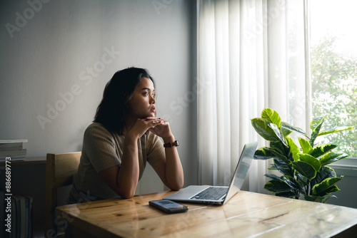 Confused concerned young woman getting problems with mobile phone while working at home, feeling stressed, frustrated