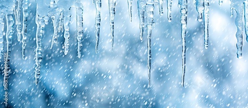 Icicles hang gracefully with a winter backdrop, perfect for a copy space image.