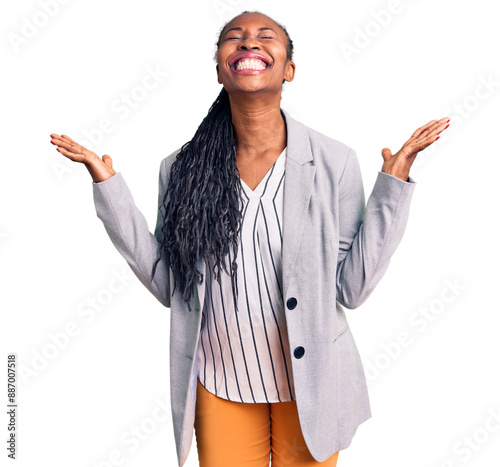 Young african american woman wearing business clothes celebrating mad and crazy for success with arms raised and closed eyes screaming excited. winner concept