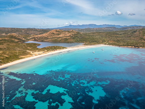 Aerial view of two yachts moored in the turquoise bay off the Plage de Balistra on the south east coast of the Mediterranean island of Corsica