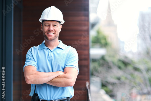 Architecture, arms crossed and portrait of happy man with safety at remodeling site, home improvement and deal plan. Engineering, contractor and confidence to hard hat, industry and face with smile