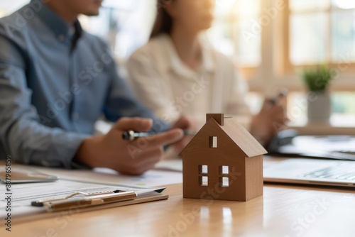 homebuying couple discussing mortgage options with a real estate agent, minimalist office settings and soft, natural lighting, decision-making process involved in purchasing a home through a mortgage