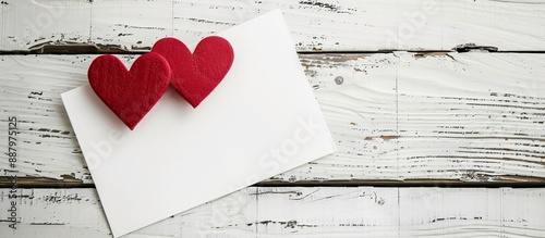 A romantic note on white wood with two red hearts ideal for inserting a picture. Copy space image. Place for adding text and design