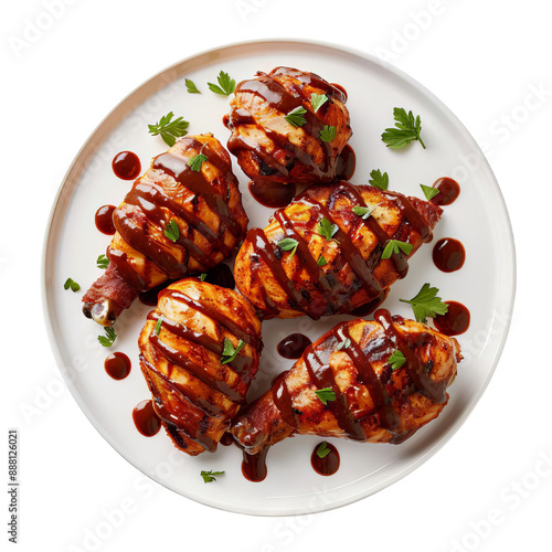 Grilled chicken drumsticks glazed with barbecue sauce on a white plate.