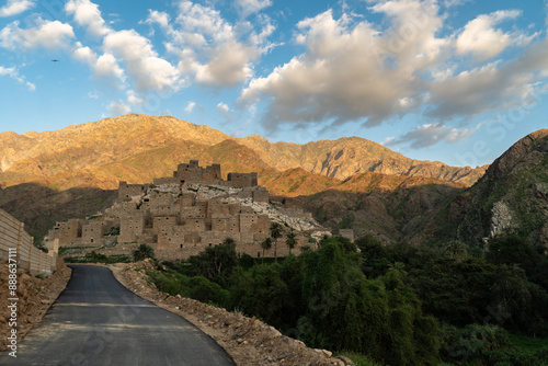 Al Bahah, Saudi Arabia: The road toward the Thee Ain, or Zee Ain ancient village in the mountains of Saudi Arabia in late afternoon with a cloudy blue sky