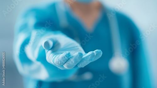 Gloved hand of a medical professional reaching out.