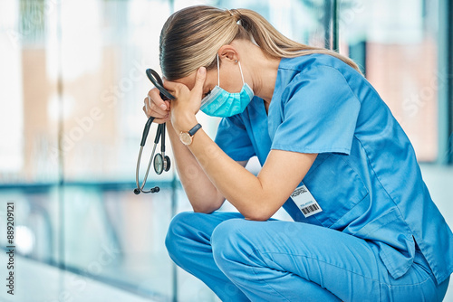 Stress, tired nurse and woman in hospital with depression, burnout or anxiety for mistake. Sad, surgery fail and medical worker with grief, fatigue or headache in healthcare clinic with stethoscope