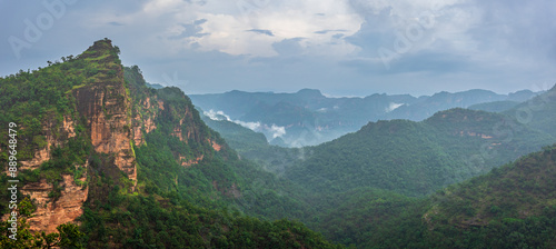 Panoramic view of Pachmarhi valley having clouds and mist shrouded hills rolling on each other from vantage point Priyadarshini Point in Pachmarchi, Madhya Pradesh, India.