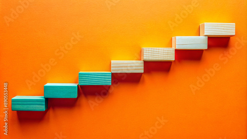 Wooden blocks forming a timeline with milestones on a bright orange background.