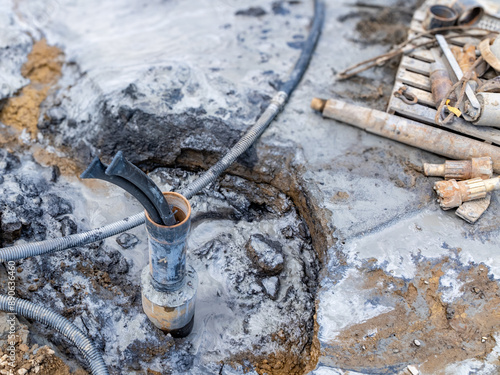 Casing pipe with polyethylene ground loop pipes in the process of being installed in a new geothermal well field. 