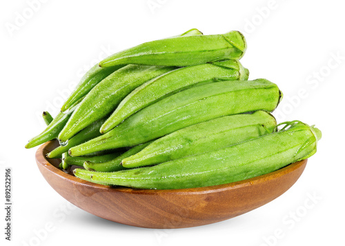 Pile of fresh green okra in a wooden bowl isolated on white background