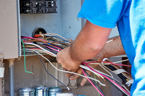 Electrician installing a transfer panel for a whole house generator