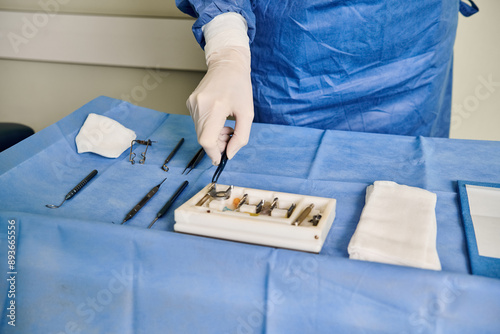 Patient in hospital gown readies surgical tool for laser vision correction.