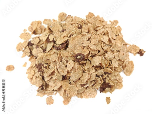 Top view of a heap of rice and wheat flakes with dark chocolate bits, isolated on white background.