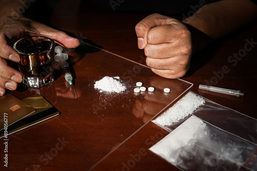 Man hand holds plastic packet drugs or bag with cocaine, drug abuse and danger addiction concept