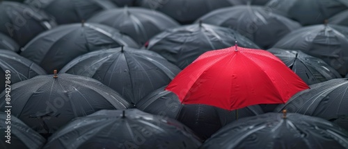 City street filled with black umbrellas, single red umbrella prominently visible, Daring to be different, Individuality in business