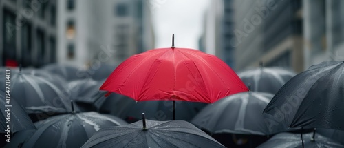 City street filled with black umbrellas, single red umbrella prominently visible, Daring to be different, Individuality in business