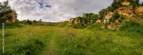 Panorama of disused Bishop Middleham Quarry, which ceased operations in 1934 and is now a SSSI managed as a nature reserve full of wildflowers in Co. Durham, England