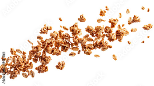 Close-up of granola scattered against a white background. Healthy breakfast food with oats, nuts, and honey forming a textured, crunchy mix.