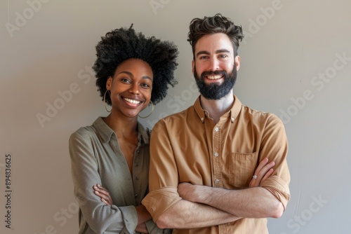 Portrait of a cheerful mixed race couple in their 30s with arms crossed