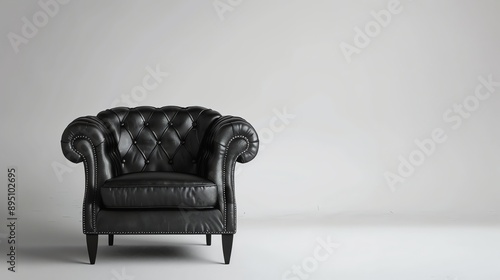 Black leather armchair on a white background. The armchair is classic in style with a tufted seat and back.