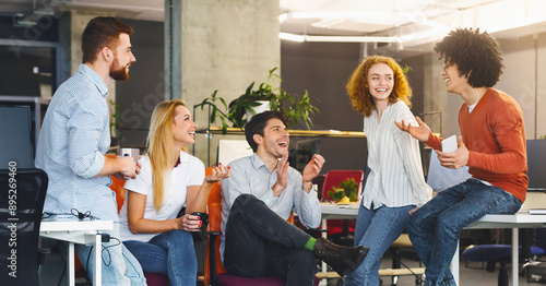 Friendship at workplace. Diverse millennial people having good talk at coworking space, panorama