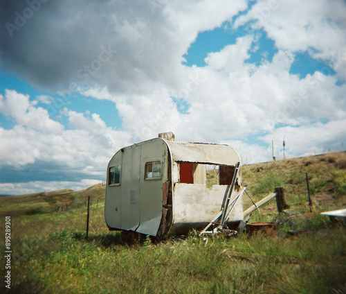 Abandoned caravan falling to pieces in a rural paddock