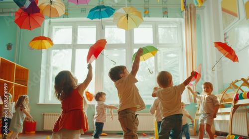 Children in a lively classroom play with colorful umbrellas, celebrating the joy of early childhood and playful learning.