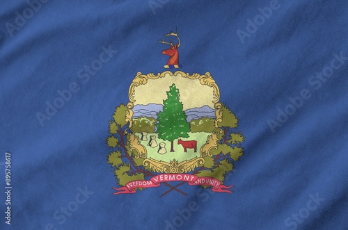 Vermont US state flag depicted on folded wavy fabric of old cloth close up