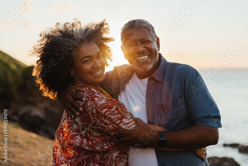 Retirement Bliss: Mature black couple embracing at sunset