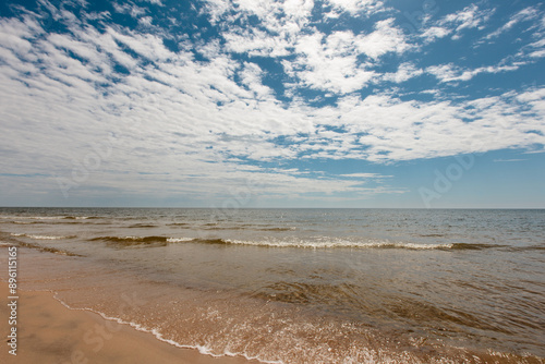 The incoming waves of Lake Michigan approach the shoreline almost perpendicular to the overhead clouds in early June at Kohler-Andrae State Park, Sheboygan, Wisconsin