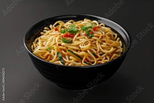 Indo Chinese Schezwan Noodles in black bowl with udon noodles vegetables and spicy sauce