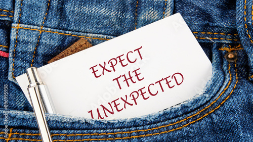 Text expect the unexpected on a piece of paper from a jeans pocket