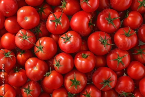 Seamless background featuring numerous fresh red tomatoes with green stems and water droplets.