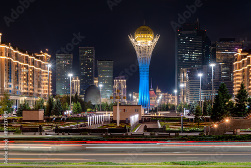 Nighttime view of the Kazakh capital, Astana, with the iconic Baiterek Tower at the center. This is a monumental observation tower and a famous tourist attraction