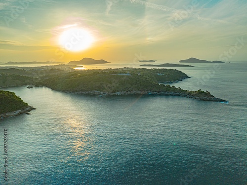 aerial view scenery sunrise at Laem Promthep Cape viewpoint. This is the most popular viewpoint in Phuket..Golden sunlight pierces the blue clouds above Promthep Cape viewpoint.