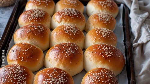 Freshly baked sesame buns, golden brown and sprinkled with sesame seeds